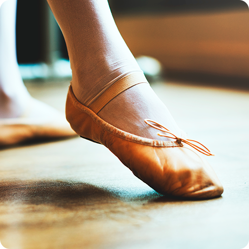 A dancer's leg and shoe close up in a pose to show dance photography and marketing material.